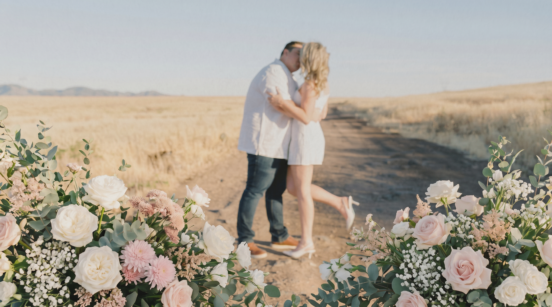 Molly and Noah standing together on a desert road at golden hour